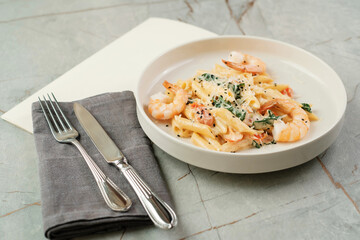 Pasta with shrimps and herbs. Seafood dish in cafe.