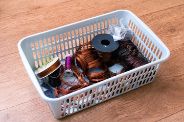 Copper wire coils in a plastic basket