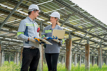 Electrical engineer on solar farm with large structure Check maintain rehearse damaged parts from use in order to produce electricity with maximum efficiency throughout its service life professionally