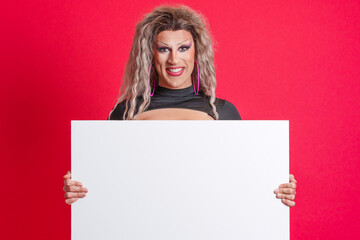 Smiley transgender person holding a blank panel in studio