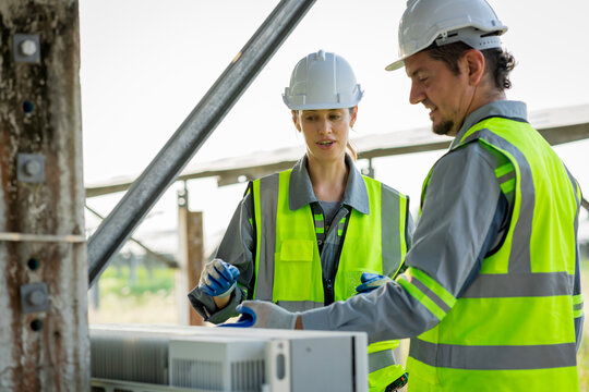 Electrical engineer on solar farm with large structure Check maintain rehearse damaged parts from use in order to produce electricity with maximum efficiency throughout its service life professionally
