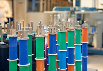 Empty spindles of industrial cotton reels in a weaving factory, machine weaving cotton for the fashion and textiles industry. Yarn weave traditional textile fabric manufacturing for clothing