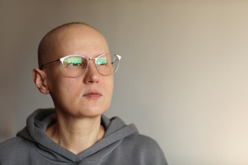 Confident bald woman in glasses struggle with oncology. Hairless cancer sick female patient after...
