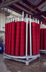 Red spindles of industrial cotton in a weaving factory, machine weaving cotton for the fashion and textiles industry. Yarn weave traditional textile fabric manufacturing for clothing and fashion.