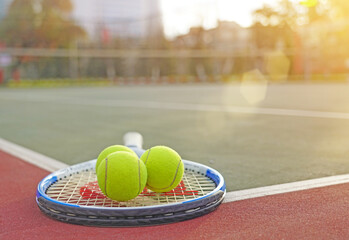 tennis racket and balls on court 