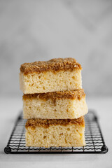 Danish Dream Cake Drømmekage. Sponge cake with coconut and brown sugar topping on a light...