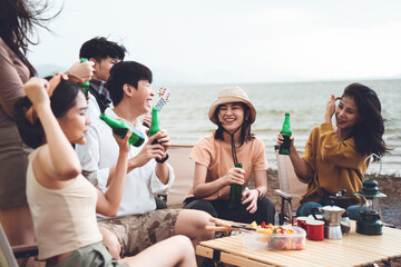 Young asian friends having fun at campyard, enjoying with beer and bbq party, Camping lifestyle on holiday summer.