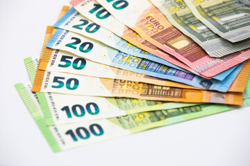 Pile of euro banknotes of 100, 50, 20, 10 and 5 euros. White background