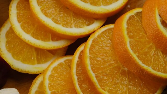 Beautiful looking orange slices on wooden board sliced with knife. Slow motion orange slice. Orange citrus fruits, making fresh juice or tropical cocktails. cooking food and desserts from citrus 4k