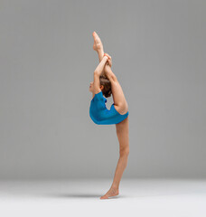 Young rhythmic gymnas showing stretch gymnast pose