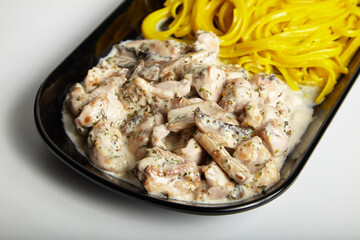 Grilled Chicken with Creamy Mushroom Sauce Linguine Pasta on Black Plate White Background