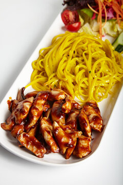 Grilled Chicken with Barbecue Sauce Linguine Pasta and Green Salad White Background