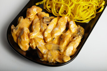 Grilled Chicken With Cheddar Sauce and Linguine Pasta with Green Salad White Background Close Up