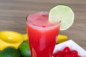 Cherry lemonade in crystal glass on brown wooden table