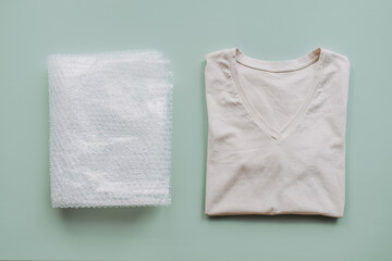 Recycle clothes concept. Recycling Fibers in the Textile Industry. Sustainable recycled cotton fiber. Recycled cloth T-shirt and bubble wrap plastic