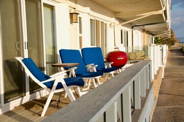 Home balcony with chairs and cooker on beach front home  Malibu California