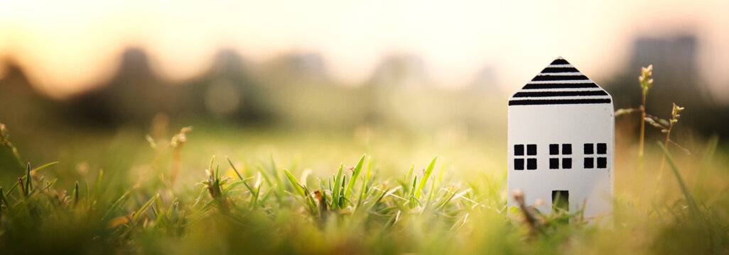 Concept image of a small house in nature. Idea of ecology, solar energy, and sustainability