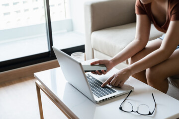 Close up Female typing on laptop keyboard working with digital data..