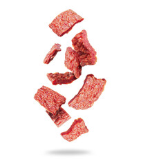 Dried pieces of beef in the air isolated on a white background