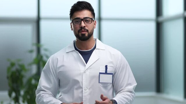 Smiling male doctor with glasses and beard