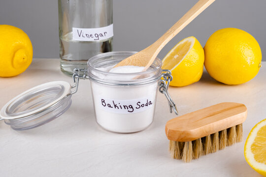 Baking soda, vinegar and lemon on a gray background.The concept ecological cleaning, disinfecting, removing stains