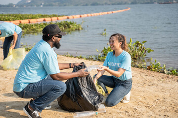Volunteers cleaning plastic at river beach. Environmental and ecological care, Earth day concept