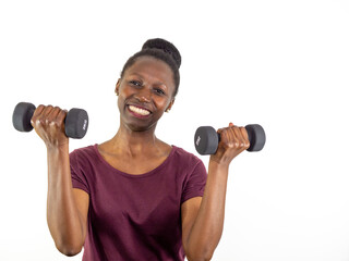 Fototapeta na wymiar Young woman lifting two dumbbells isolated on white background