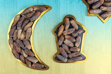 Dried dates fruits arranged in the shape of a crescent moon and Lantern.Iftar food and Ramadan concept