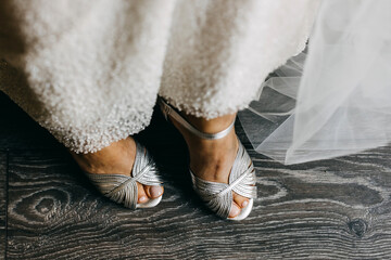 Closeup of bridal silver wedding shoes.
