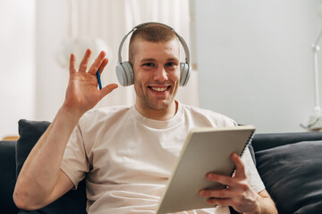 Portrait of a businessman waving at the camera for the online business meeting