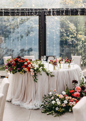 Wedding reception tables at a restaurant, decorated with centerpieces. Bride and groom table.