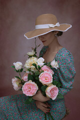 Romantic woman in hat with bouquet of flowers.Art processing