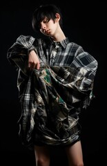 Fototapeta premium Fictional male model wearing grunge clothes, isolated on black background. Generative AI illustration.