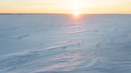 Horizon over frozen sea at sunset