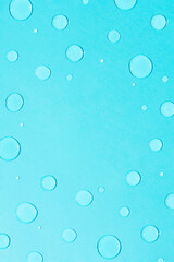 Bright pastel blue background with water and rain drops. Creative copy space. Minimal concept of water and hydration.