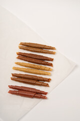 Pattern pastila fruit leather rolls up with fruits on white background. Vertically.