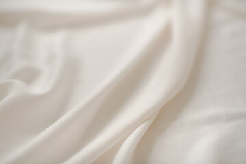Fototapeta na wymiar White or Ivory Silk Sheet Fabric, Textured Background 