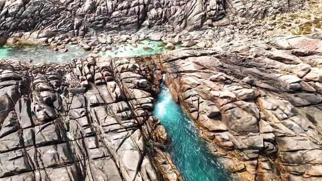 Aerial view of people at Injidup natural pool and spa along the coastline, Yallingup, Western Australia, Australia.