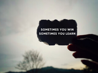 Inspirational and Motivational Concept - 'sometimes you win sometimes you learn' text background.