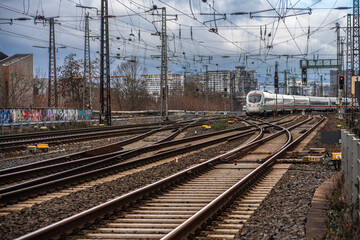 Fototapeta na wymiar tracks and overhead lines on the outskirts and moving train