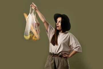 Ecology Concept. Woman holding cotton grocery bag with vegetables. Reusable eco bag for shopping. Zero waste concept. Eco friendly lifestyle. Isolated white background.