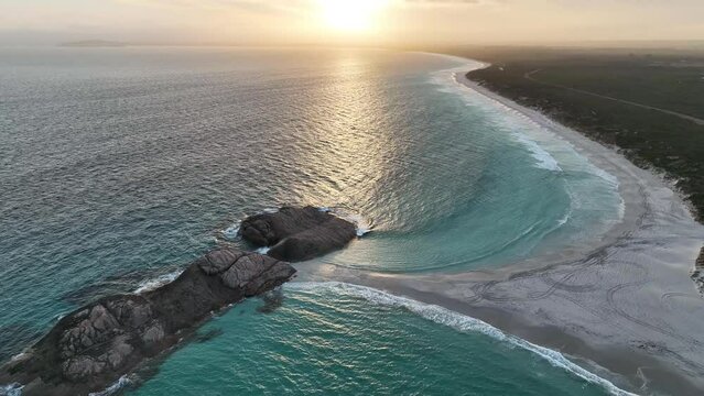 Aerial view of Wylie Bay, a long coastline at sunset, Western Australia, Australia.