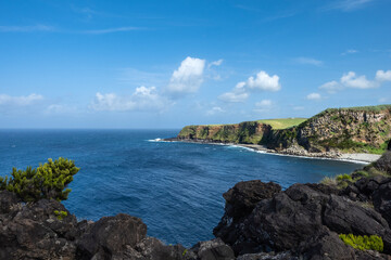 Azores Clear Blue Ocean with Black Basalt Shore and Wispy Clouds