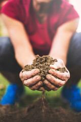 Senior woman holding soil in her hands