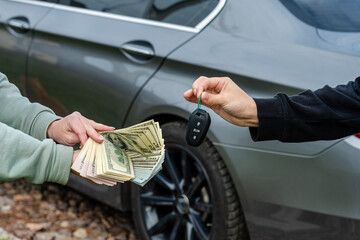 Deal of buy or rental car concept. Exchange money and car keys