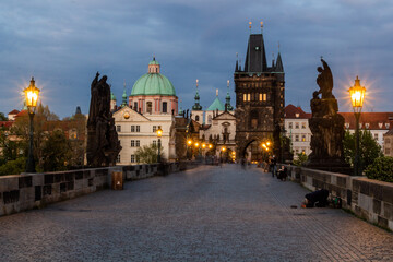 Fototapeta na wymiar PRAGUE, CZECHIA - APRIL 27, 2020: Evening at the Charles Bridge in Prague, Czech Republic