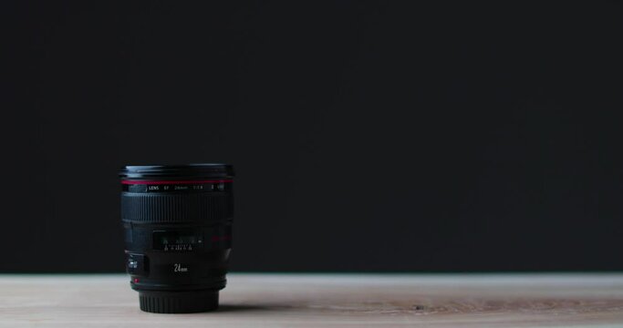 Camera lens on white studio table with black background camera equipment. High quality 4k footage