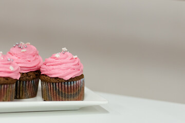 Holiday cupcakes with pink cream and raspberry filling. Close up