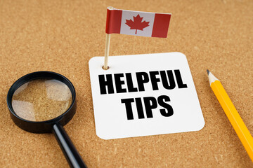 On the table is the flag of Canada, a pencil, a magnifying glass and a sheet of paper with the...