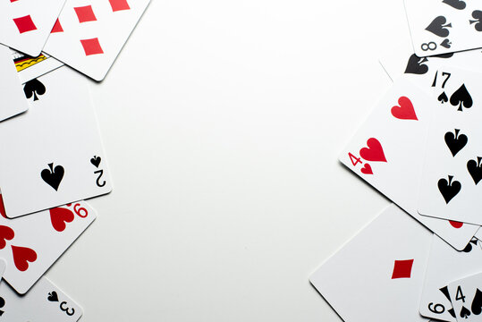 Scattered Cards Bordering the Right and Left on a White Background